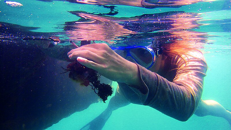 Diver with algae under water